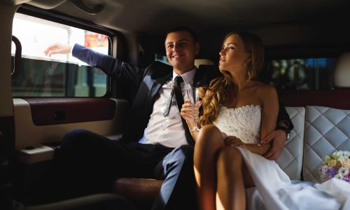 Newlyweds in a car Wedding limo